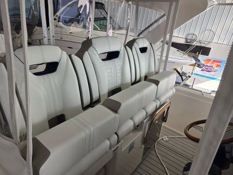 Slide: The Image of The 2010 Sea Ray Sundancer 310 features white leather seats in the cockpit. - 12