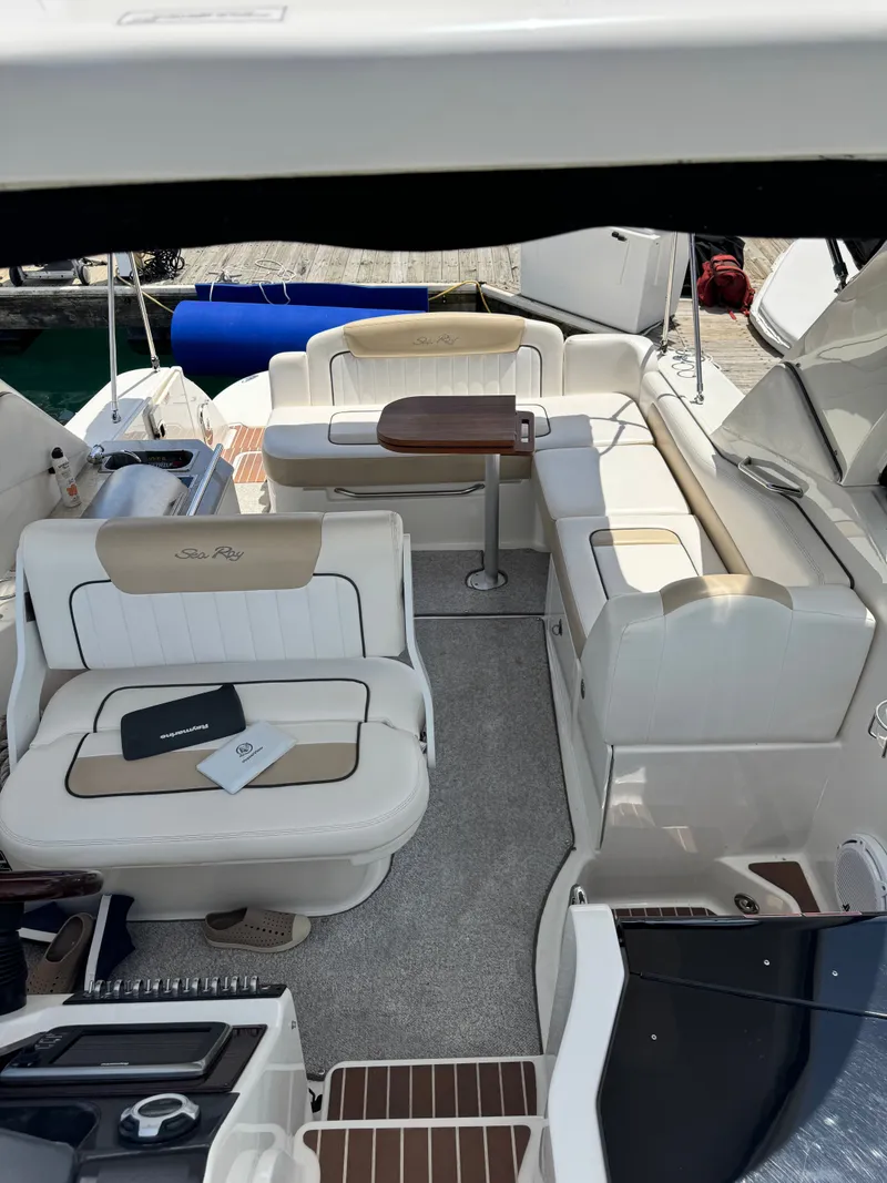 Slide: The Image of The image shows the cockpit of a 2010 Sea Ray Sundancer 310 with beige seating. - 11