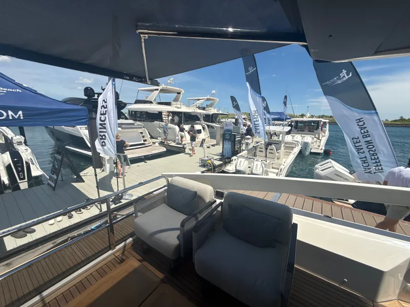 Slide: The Image of A 2010 Sea Ray Sundancer 310 is docked in a sunny marina alongside other boats. - 13