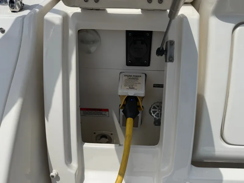 Slide: The Image of A power connection on a boat with a yellow cable and socket. - 49