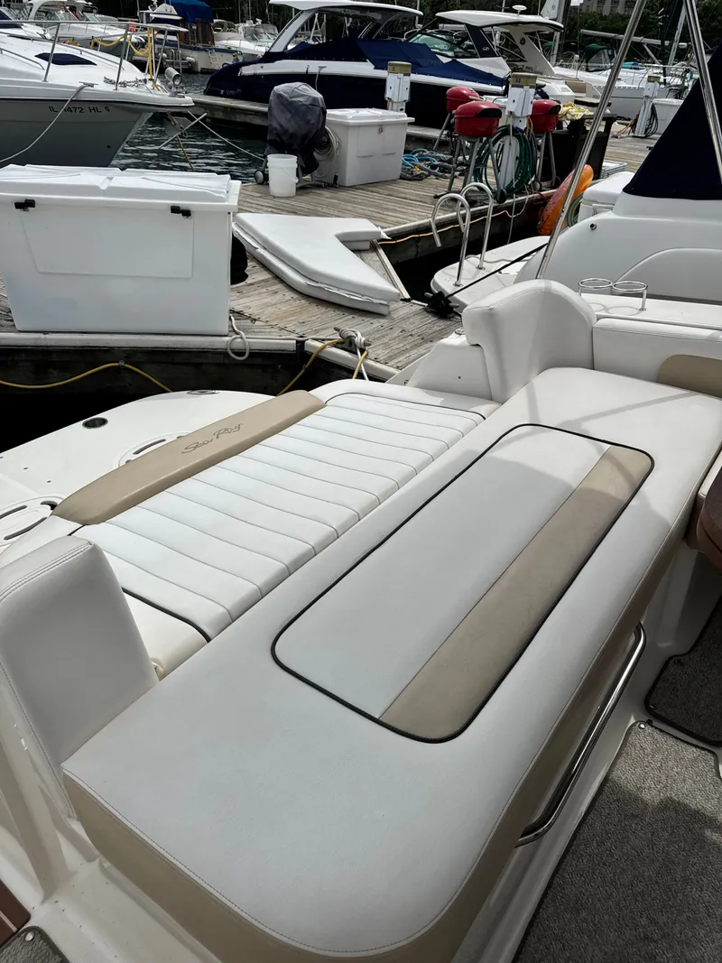 Slide: The Image of The image shows the cockpit of a Sea Ray Sundancer 310 with comfortable seating and a lounging area. - 6