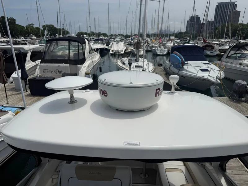 Slide: The Image of A 2010 Sea Ray Sundancer 310 docked in a busy marina with many other boats. - 45