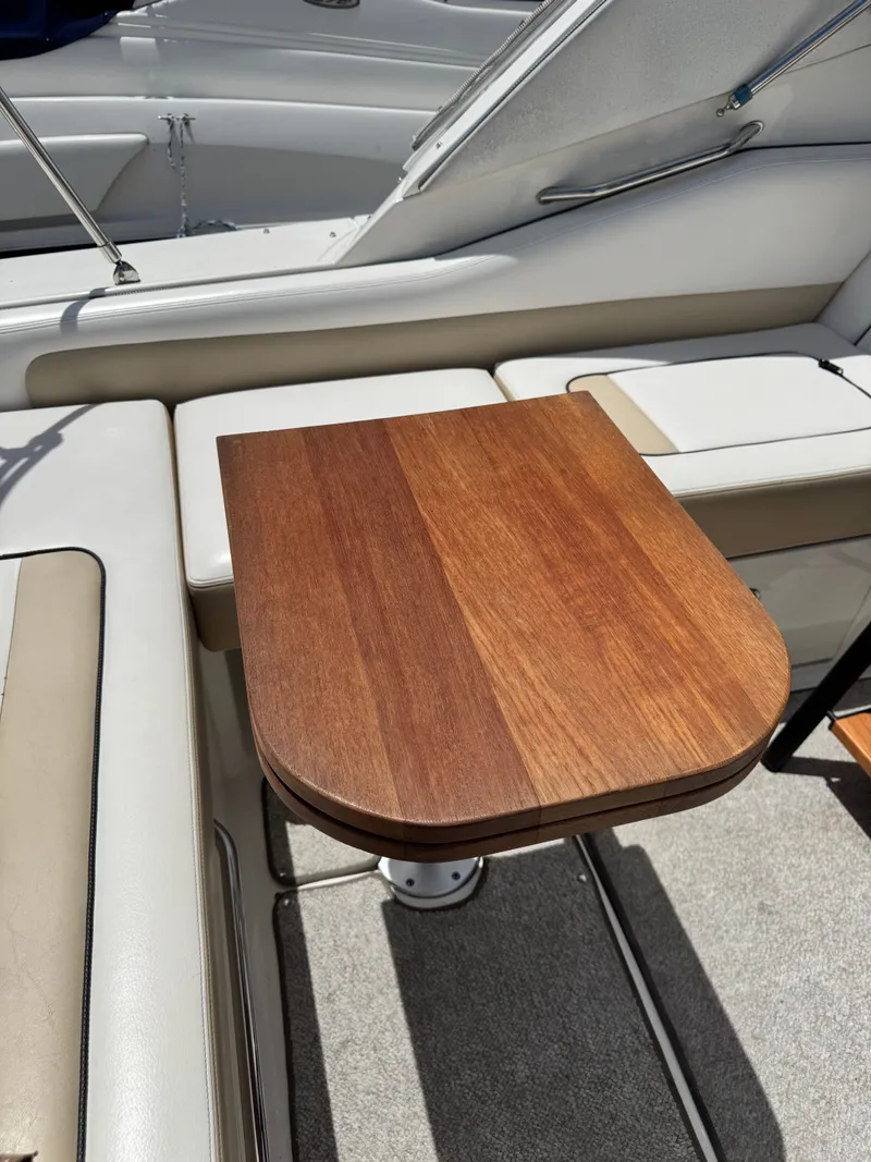 Slide: The Image of A sleek wooden table on a 2010 Sea Ray Sundancer 310 boat. - 29