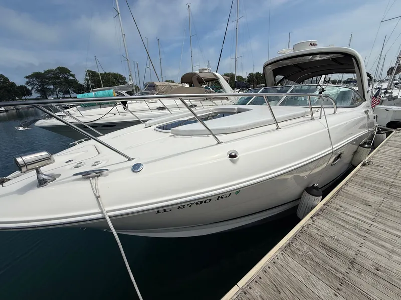 Slide: The Image of A 2010 Sea Ray Sundancer 310 docked at a wooden pier in a marina. - 1