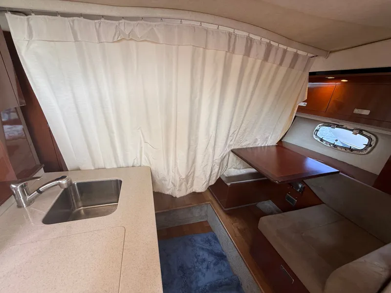 Slide: The Image of Interior of a 2010 Sea Ray Sundancer 310 with a kitchenette and seating area. - 41