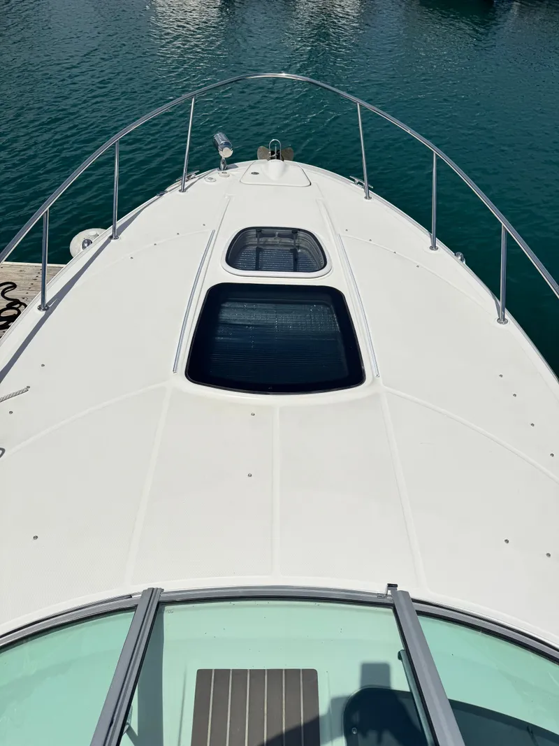 Slide: The Image of The image shows the foredeck of a 2010 Sea Ray Sundancer 310. - 16