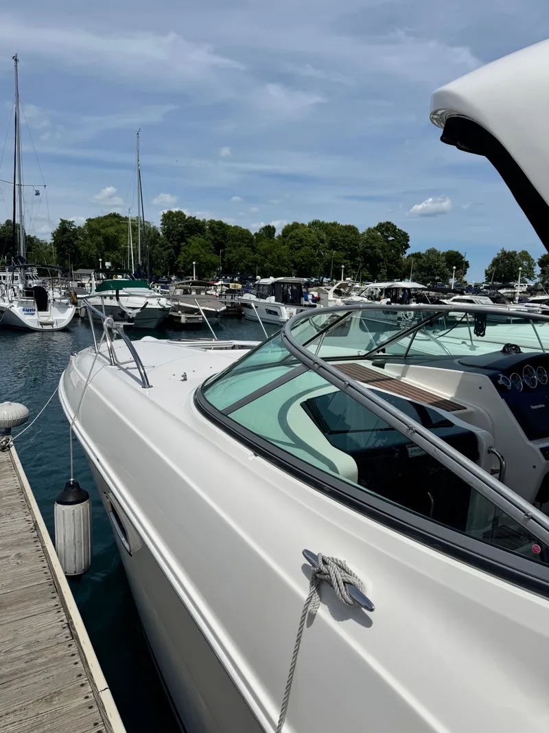 Slide: The Image of A 2010 Sea Ray Sundancer 310 docked. Other boats are visible in the background. - 2