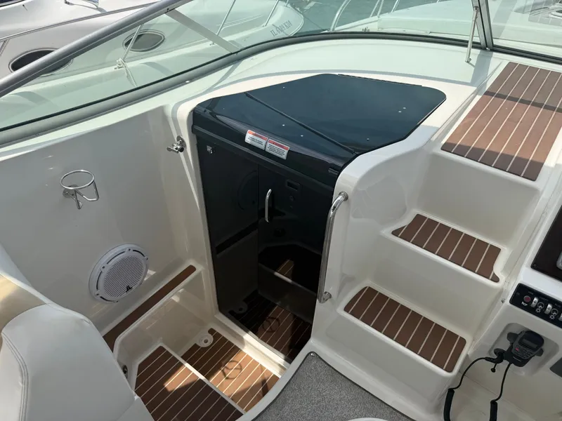 Slide: The Image of The image shows the cockpit of a 2010 Sea Ray Sundancer 310 with white and wood-toned details. - 24