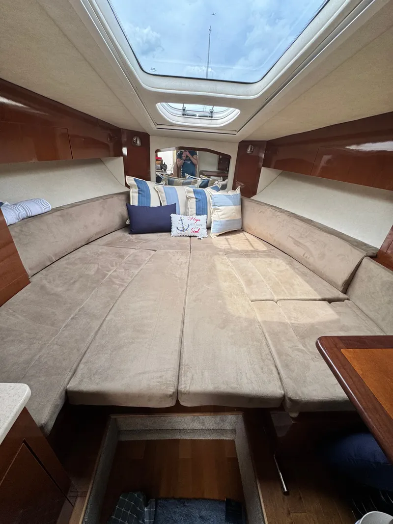 Slide: The Image of Interior of a Sea Ray Sundancer 310 with beige upholstery and skylights. - 26