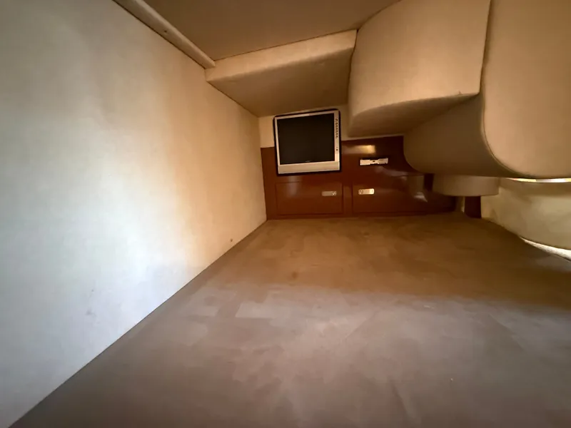 Slide: The Image of Interior of a 2010 Sea Ray Sundancer 310 with a TV and storage space. - 38