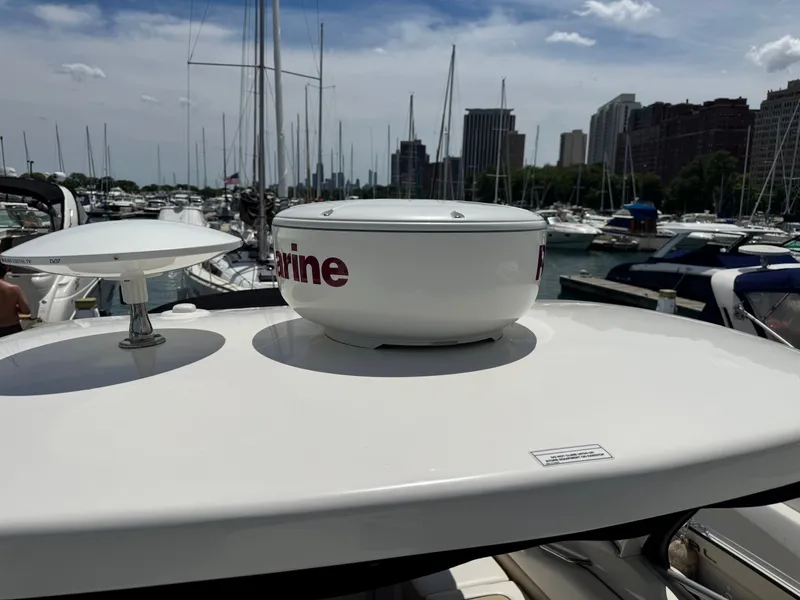 Slide: The Image of A 2010 Sea Ray Sundancer 310 in a marina, surrounded by other boats. - 30