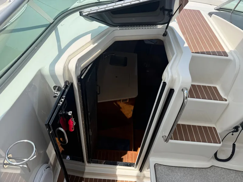 Slide: The Image of The 2010 Sea Ray Sundancer 310 features a cabin entrance with wooden steps and stainless steel handles. - 26