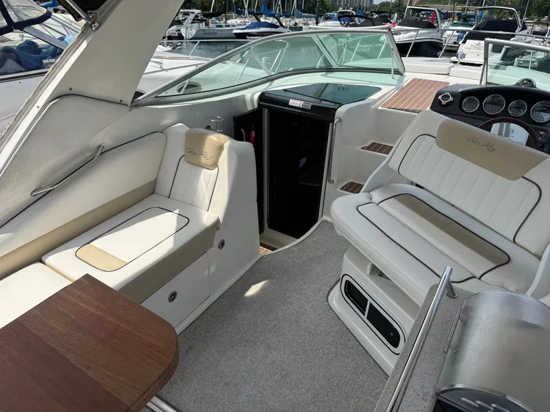 Slide: The Image of The image shows the cockpit of a 2010 Sea Ray Sundancer 310 with beige seating. - 12