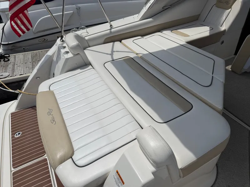 Slide: The Image of The image shows the stern of a 2010 Sea Ray Sundancer 310 with comfortable lounging areas. - 21