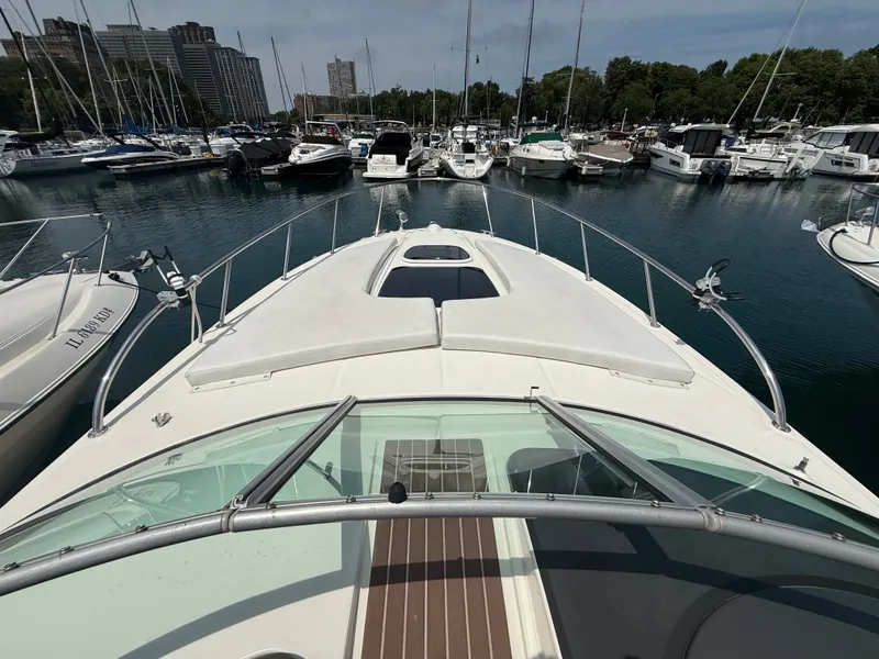 Slide: The Image of The image shows the foredeck of a 2010 Sea Ray Sundancer 310 in a marina. - 5