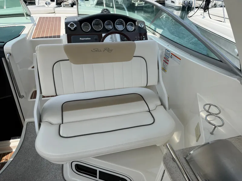 Slide: The Image of The image shows the cockpit of a 2010 Sea Ray Sundancer 310 with a white seat. - 16