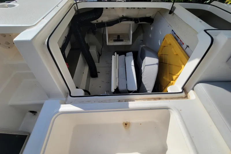 Slide: The Image of 2023 Bayliner VR6 Bowrider OB storage compartment with seating and equipment. - 17