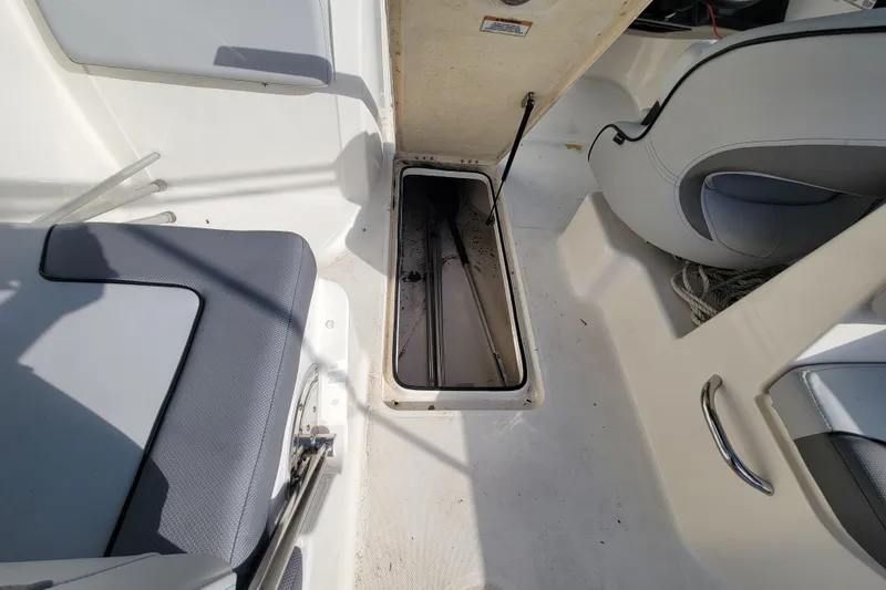 Slide: The Image of 2023 Bayliner VR6 Bowrider OB interior with open storage compartment and seating. - 21