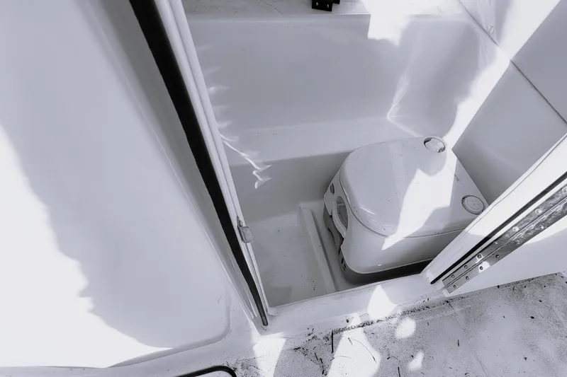 Slide: The Image of 2023 Bayliner VR6 Bowrider OB interior with compact marine toilet. - 24