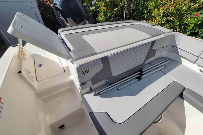 Slide: The Image of 2023 Bayliner VR6 Bowrider OB interior with seating and storage compartments. - 16