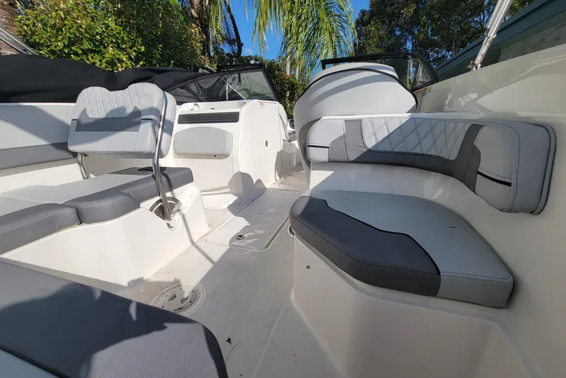 Slide: The Image of 2023 Bayliner VR6 Bowrider OB interior with gray seating and open deck layout. - 14