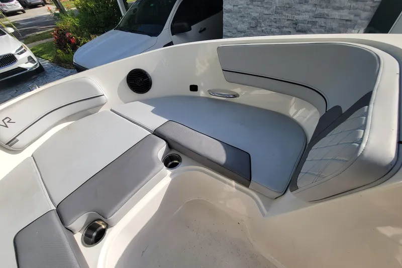 Slide: The Image of 2023 Bayliner VR6 Bowrider OB interior with cushioned seating and cup holders. - 26