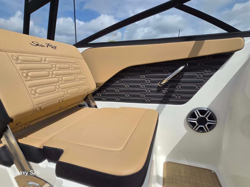 Slide: The Image of The image shows the interior of a Sea Ray SPX 210 boat with beige seating and modern details. - 8