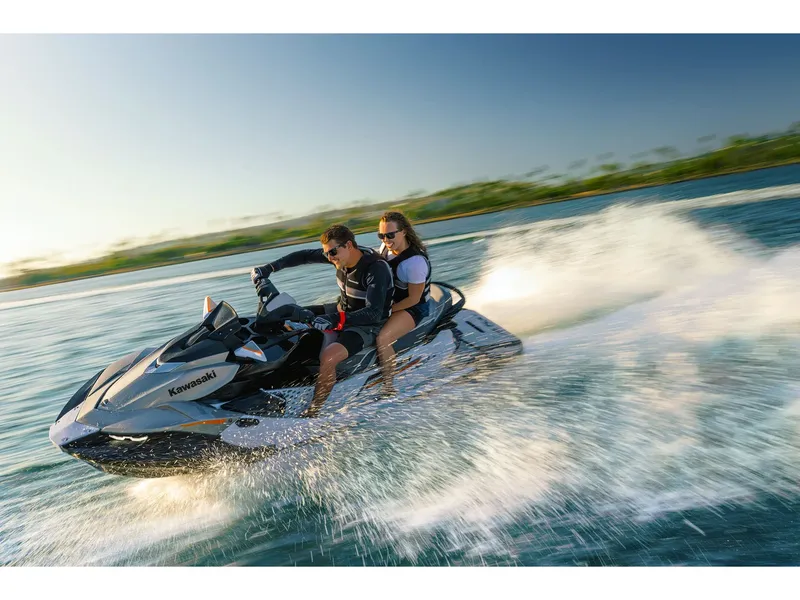 Slide: The Image of Two people ride a Kawasaki Jet Ski® STX® 160LX across the water. - 16