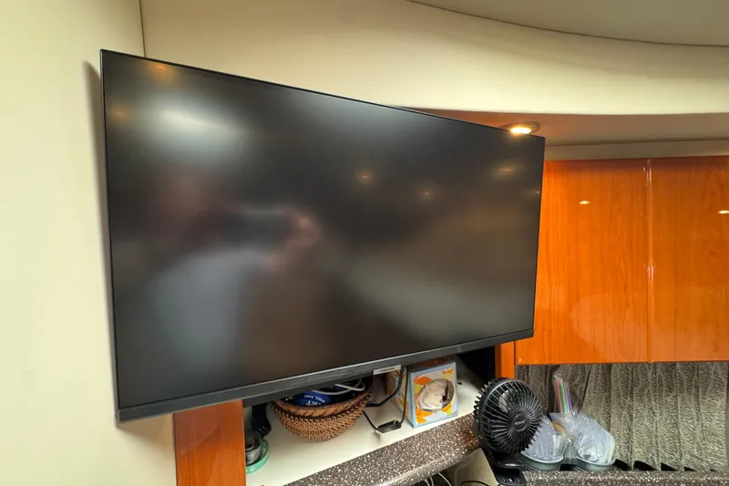 Slide: The Image of Flat-screen TV in 2004 Formula 37 Performance Cruiser interior, with fan and storage below. - 24