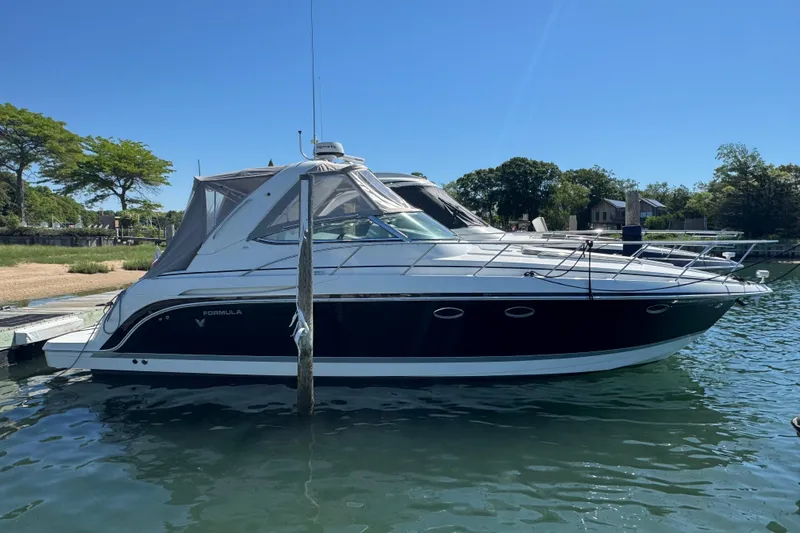 The Image of 2004 Formula 37 Performance Cruiser docked on a sunny day, showcasing sleek design. - 0
