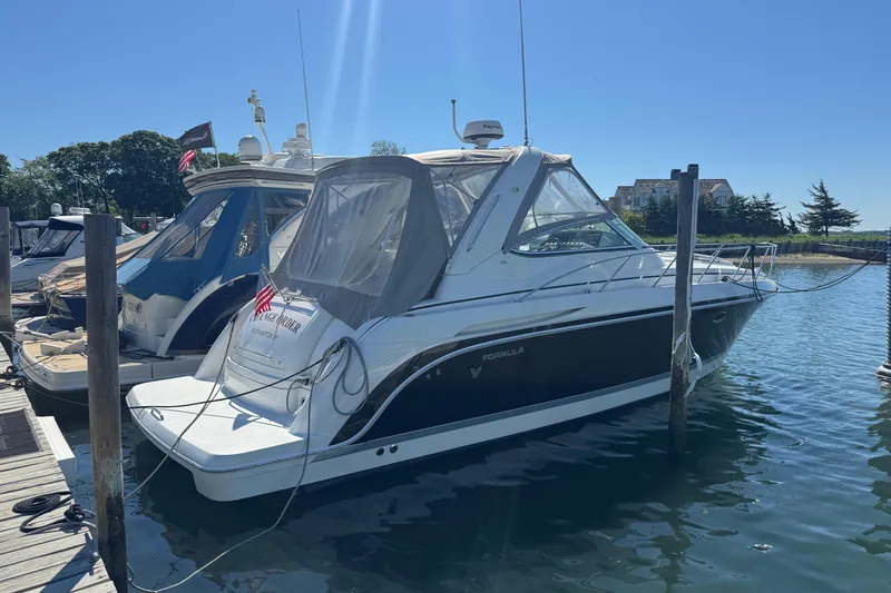 Slide: The Image of 2004 Formula 37 Performance Cruiser docked in a sunny marina setting. - 3