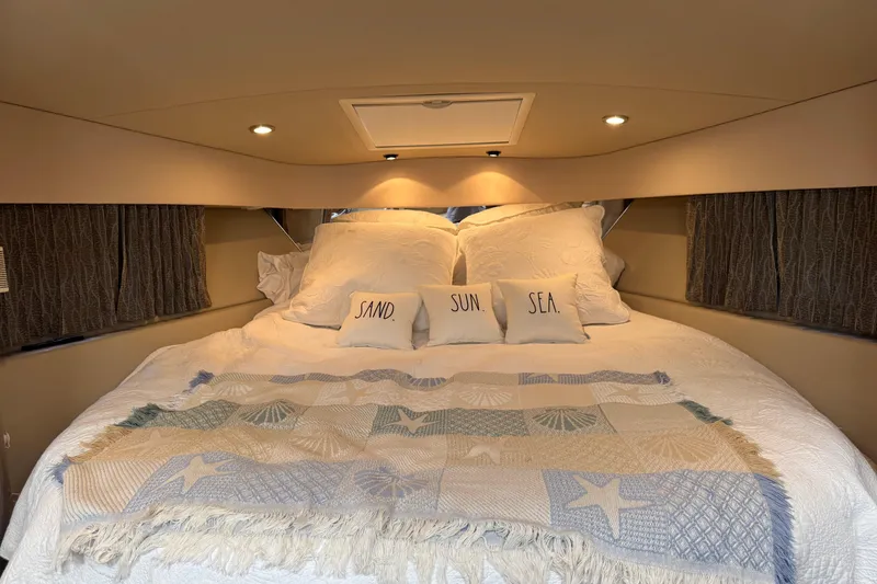 Slide: The Image of Cozy cabin bedroom in 2004 Formula 37 Performance Cruiser with nautical-themed decor. - 27