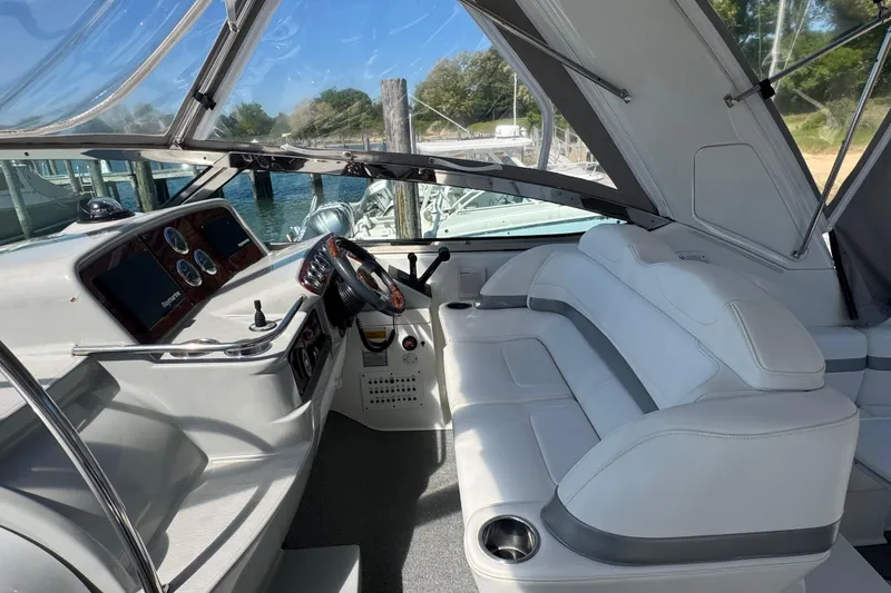 Slide: The Image of 2004 Formula 37 Performance Cruiser interior with helm, seating, and dashboard at marina. - 13