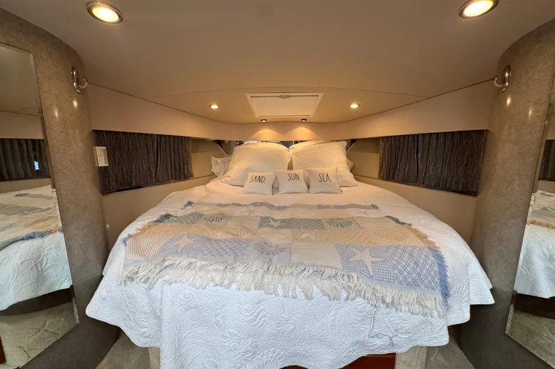 Slide: The Image of Cozy cabin interior of 2004 Formula 37 Performance Cruiser with nautical-themed bedding. - 26
