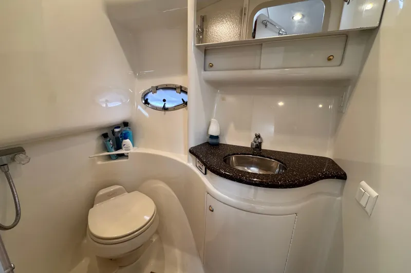 Slide: The Image of 2004 Formula 37 Performance Cruiser bathroom with sink, toilet, and porthole window. - 30
