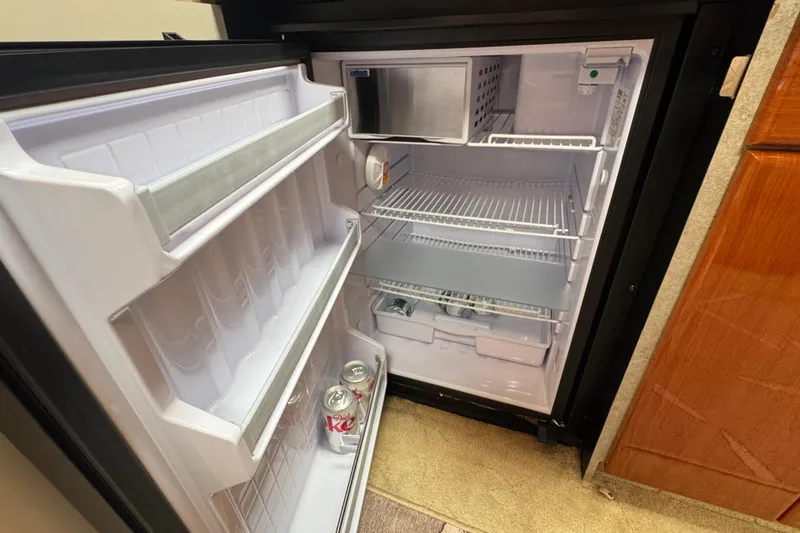 Slide: The Image of Open refrigerator in 2004 Formula 37 Performance Cruiser, containing Diet Coke cans. - 20