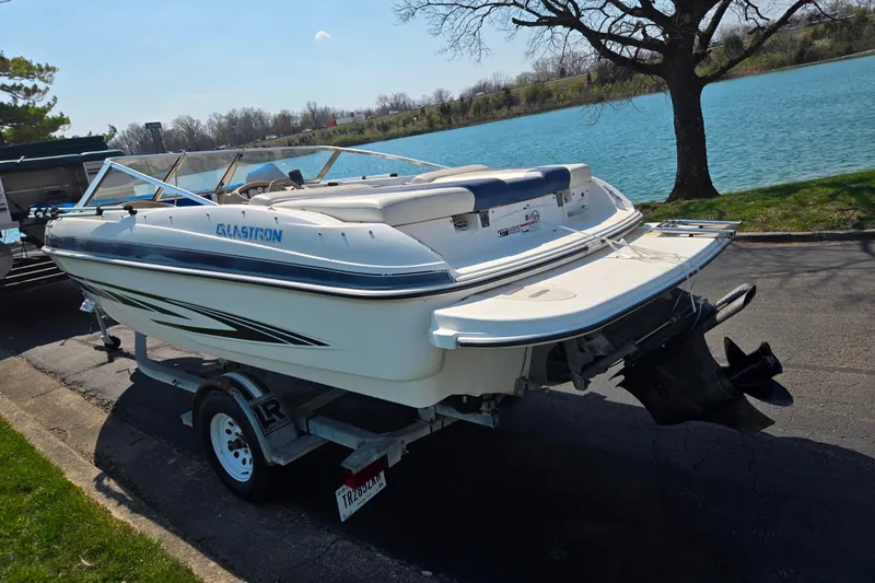 Slide: The Image of 2007 Glastron GT 185 boat on trailer by a scenic lake. - 1