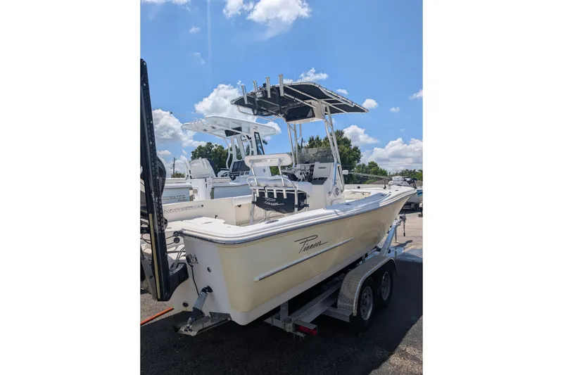 The Image of 2009 Pioneer 220 Bay Sport boat on trailer under blue sky. - 0