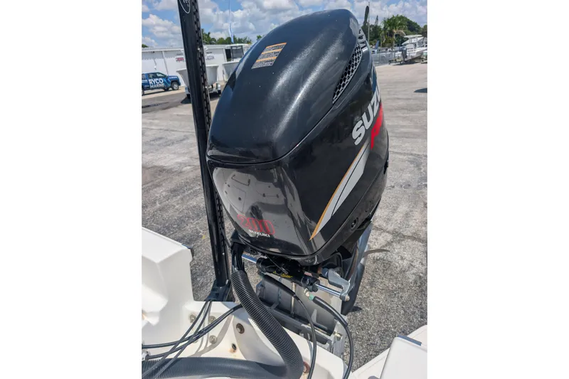 Slide: The Image of Outboard motor on a 2009 Pioneer 220 Bay Sport boat, parked outdoors. - 7