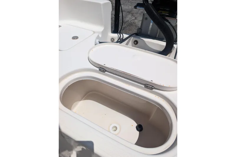 Slide: The Image of Open storage compartment on a 2009 Pioneer 220 Bay Sport boat. - 6