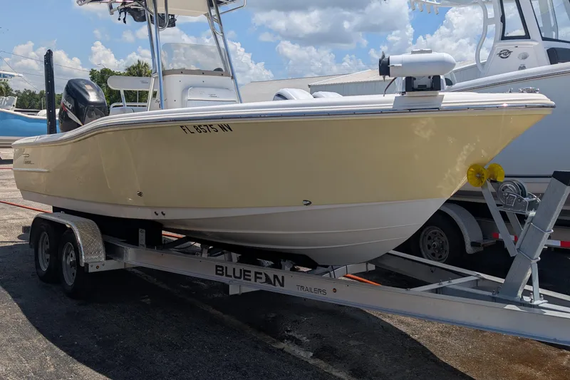 Slide: The Image of 2009 Pioneer 220 Bay Sport boat on trailer, sunny day, parked outdoors. - 1