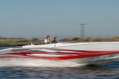 The Image of 2013 Nordic 39 POKER RUN speedboat with red and white design on water. - 1