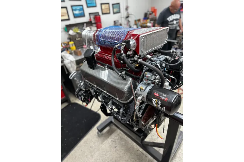 Slide: The Image of High-performance engine of a 2013 Nordic 39 POKER RUN boat in a workshop setting. - 38