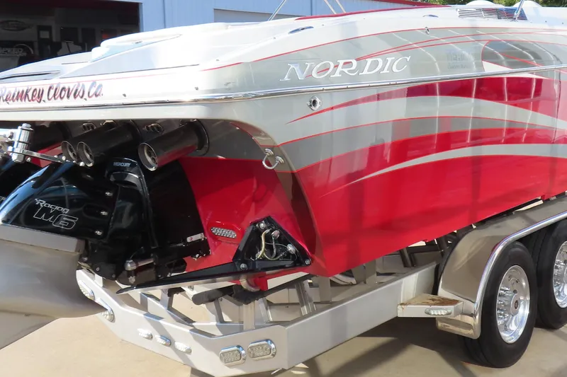 Slide: The Image of 2013 Nordic 39 Poker Run boat with red and silver design, featuring Mercury Racing M6 engine. - 8