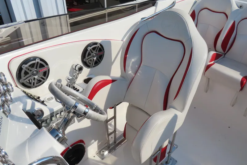 Slide: The Image of Interior of 2013 Nordic 39 POKER RUN boat with white and red seating, steering wheel, and speakers. - 24