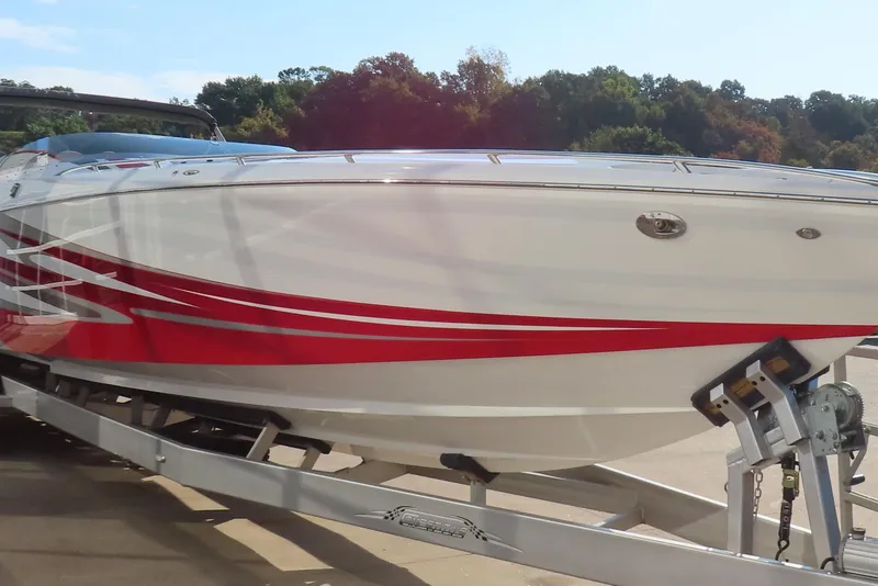 Slide: The Image of 2013 Nordic 39 Poker Run boat with red stripes on a trailer. - 7