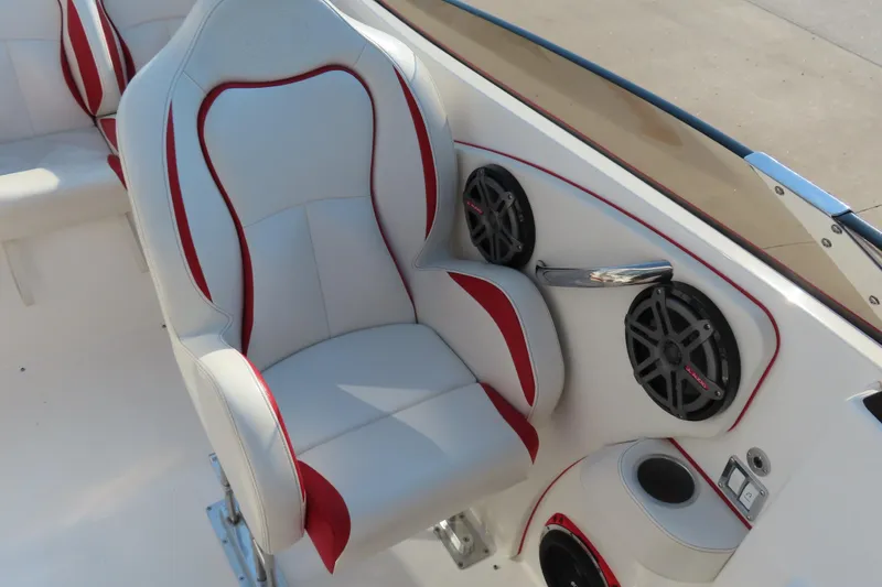 Slide: The Image of Luxurious seating in 2013 Nordic 39 POKER RUN boat with red accents and built-in speakers. - 27