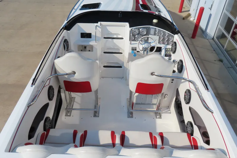 Slide: The Image of 2013 Nordic 39 POKER RUN boat interior with white and red seating, modern dashboard. - 18