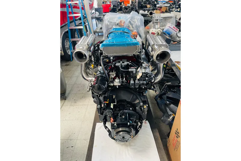 Slide: The Image of 2013 Nordic 39 Poker Run engine in workshop, featuring dual exhausts and blue components. - 34