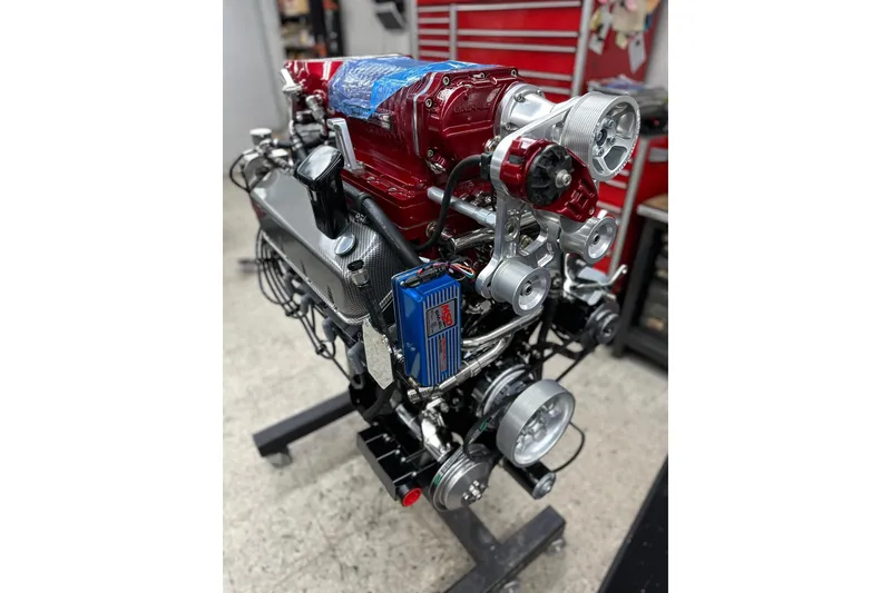 Slide: The Image of High-performance engine of a 2013 Nordic 39 Poker Run boat in a workshop setting. - 37